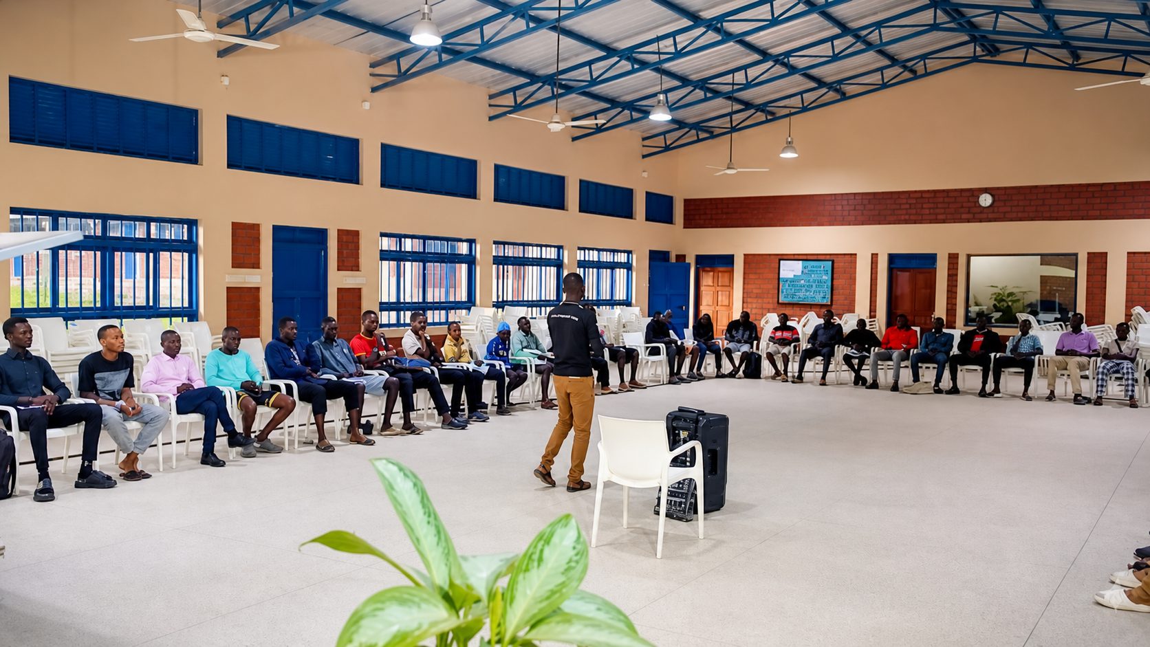 Boys and mentors gathered indoors during a camp session